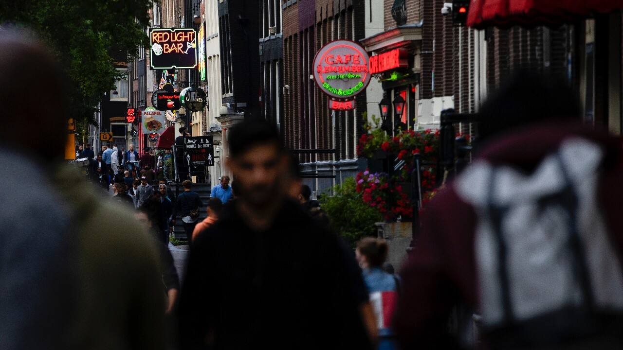 People walk in the Red Light District as sex workers welcomed clients again in Amsterdam, Netherlands, July 1. (AP Photo/Peter Dejong)