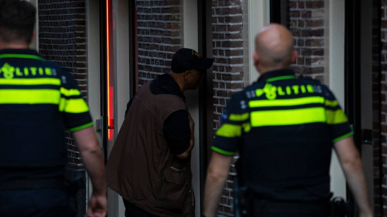 Two police officers patrol the streets as sex workers welcomed clients again in the Red Light District in Amsterdam, Netherlands, July 1. (AP Photo/Peter Dejong)