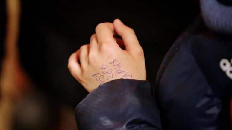 phone number written on child's hand