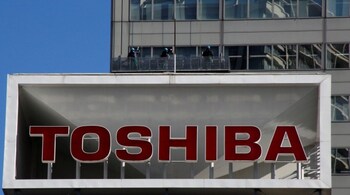 The logo of Toshiba Corp is seen as window cleaners work on the company's headquarters in Tokyo, Japan, February 14, 2017. REUTERS/Toru Hanai TPX IMAGES OF THE DAY - RTSYJK2