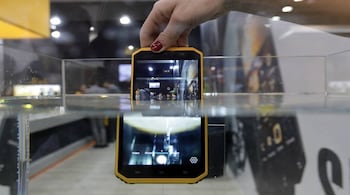 A woman presents a E&amp;L waterproof mobile phone during Mobile World Congress in Barcelona, Spain, February 28, 2017. REUTERS/Eric Gaillard - RTS10TAU