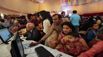 A stockbroker trades as his family watches during the Diwali special trading session celebrating the annual Hindu festival of lights at the Bombay Stock Exchange (BSE) in Mumbai October 23, 2014. Indian shares rose in a special "muhurat" trading session for Diwali on Thursday, led by gains in Suzlon Energy Ltd. while hopes for continued foreign fund inflows into the country also boosted sentiment. REUTERS/Shailesh Andrade (INDIA - Tags: BUSINESS RELIGION) - RTR4BCQP