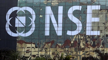 Buildings are reflected on the glass windows of the NSE (National Stock Exchange) building in Mumbai, India, December 27, 2016. Picture taken December 27, 2016. REUTERS/Shailesh Andrade - RTX2WSSZ
