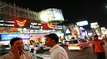 BANGALORE, INDIA - APRIL 11: (ISRAEL OUT) A man talks on his cellular phone, on April 11, 2008 in Bangalore, India. Many residents work for multi-national cooperations and the economy is booming. New construction for offices is under way. Shopping malls open frequently and the shops are full of western merchandise for workers with high disposable income. India's new middle class is about 300 million, and growing. (Photo by Uriel Sinai/Getty Images)