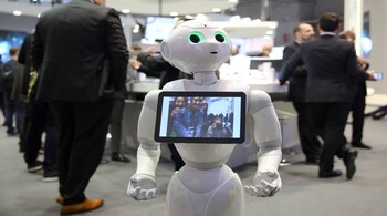 A robot displays a photograph it took of attendees at the Oberthur Technologies stand at the Mobile World Congress in Barcelona, Spain March 1, 2017. REUTERS/Paul Hanna - RTS110I2