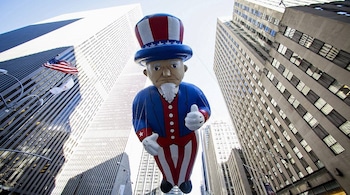 An Uncle Sam balloon floats down Sixth Avenue during the 87th Macy's Thanksgiving Day Parade in New York November 28, 2013. REUTERS/Eric Thayer (UNITED STATES - Tags: SOCIETY ENTERTAINMENT TPX IMAGES OF THE DAY) - RTX15WM0
