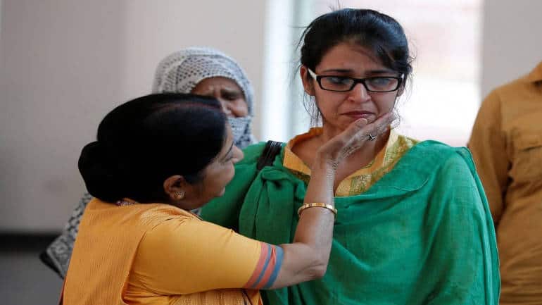 India's External Affairs Minister Sushma Swaraj consoles Uzma, an Indian woman who according to local media was forced to marry a Pakistani man, after her arrival, in New Delhi, India May 25, 2017. REUTERS/Adnan Abidi - RTX37KXP