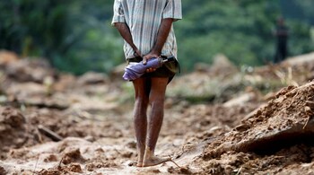 A man looks at the landslide site during a rescue mission in Athwelthota village, in Kalutara, Sri Lanka May 28, 2017. REUTERS/Dinuka Liyanawatte - RTX37Y8T