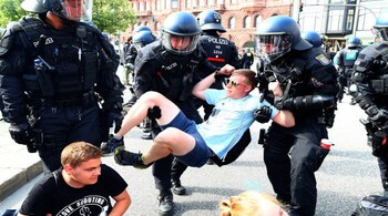 German police remove protestors who are blocking a street at a demonstration during the G20 summit in Hamburg, Germany, July 7, 2017. REUTERS/Pawel Kopczynski - RTX3AF92