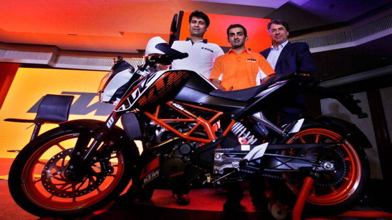 NEW DELHI, INDIA - NOVEMBER 20: (L-R) Mr. Rajiv Bajaj, MD Bajaj Auto Ltd., Indian Cricketer Gautam Gambhir and Mr. Stefan Pierer, and CEO KTM Sportmotorcycles AG, Bajaj during the launch of KTM Duke 390 on November 20, 2013 in New Delhi, India. KTM Duke 390, which was launched in India for a starting price of Rs 1.8 lakh, is the best selling bike in the 400cc segment. (Photograph by Raj k Raj/Hindustan Times via Getty Images)