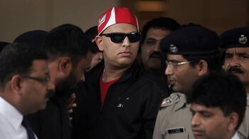 Indian cricketer Yuvraj Singh (wearing red cap) arrives at the Indira Gandhi International Airport in New Delhi April 9, 2012. Singh who underwent three cycles of chemotherapy in United States for a rare germ cell cancer between his lungs, arrived back on Monday, local media reported. REUTERS/Adnan Abidi (INDIA - Tags: SPORT HEALTH CRICKET) - RTR30IOM