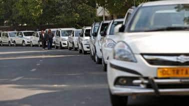 Drivers of Uber and Ola walk next to their parked vehicle's during a protest in New Delhi, India, February 14, 2017. REUTERS