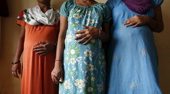 Surrogate mothers (L-R) Daksha, 37, Renuka, 23, and Rajia, 39, pose for a photograph inside a temporary home for surrogates provided by Akanksha IVF centre in Anand town, about 70 km (44 miles) south of the western Indian city of Ahmedabad August 27, 2013. India is a leading centre for surrogate motherhood, partly due to Hinduism's acceptance of the concept. The world's second test tube baby was born in Kolkata only two months after Louise Brown in 1978. Rising demand from abroad for Indian surrogate mothers has turned "surrogacy tourism" there into a billion dollar industry, according to a report by the Law Commission of India. Picture taken August 27, 2013. REUTERS/Mansi Thapliyal (INDIA - Tags: HEALTH SOCIETY TPX IMAGES OF THE DAY)
ATTENTION EDITORS: PICTURE 18 33 FOR PACKAGE 'SURROGACY IN INDIA'
TO FIND ALL SEARCH 'SURROGACY ANAND' - RTR3FFER