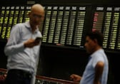 Nifty, Sensex give up morning gains to hover near flatline; realty, PSU bank stocks shine