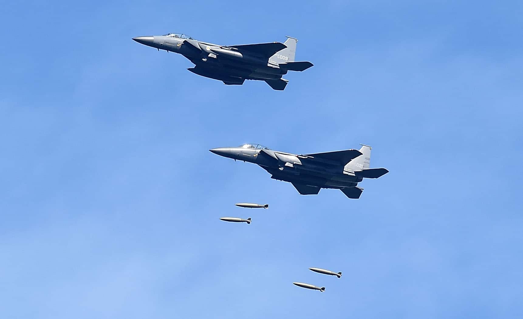 GANGWON-DO, SOUTH KOREA - AUGUST 29: In this handout image provide by South Korean Defense Ministry, South Korea's F-15K fighter jets drop bombs during a training at the Taebaek Pilsung Firing Range on August 29, 2017 in Gangwon-do, South Korea. The ballistic missile launched by North Korea flew over Northern Japan and fell into the Pacific Ocean. (Photo by South Korean Defense Ministry via Getty Images)