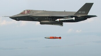 BF-3, a short take-off and vertical landing F-35 Lightning II, releases an inert 1,000 lb. GBU-32 Joint Direct Attack Munition (JDAM) separation weapon over water in an Atlantic test range in Patuxent River, Maryland August 8, 2012. A Lockheed Martin Corp F-35 Joint Strike Fighter aircraft has dropped its first bomb in a new test stage of the Pentagon's costliest weapons purchase, officials said August 9, 2012. REUTERS/Andy Wolfe/Lockheed Martin/Handout (UNITED STATES - Tags: MILITARY TPX IMAGES OF THE DAY) FOR EDITORIAL USE ONLY. NOT FOR SALE FOR MARKETING OR ADVERTISING CAMPAIGNS. THIS IMAGE HAS BEEN SUPPLIED BY A THIRD PARTY. IT IS DISTRIBUTED, EXACTLY AS RECEIVED BY REUTERS, AS A SERVICE TO CLIENTS - GM2E88A0LJR01