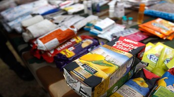 SRINAGAR, INDIA - DECEMBER 7: Army soldiers displays arms, ammunition and food packets made in Pakistan, recovered from the six slain militants killed in Mohra Uri operation and Handawara at the army headquarters on December 7, 2014 in Srinagar, India. The Army said it had enough evidence to show that the six terrorists who carried out the attack belonged and supported by Pakistani establishment and were highly trained for special operations. (Photo by Waseem Andrabi /Hindustan Times via Getty Images)