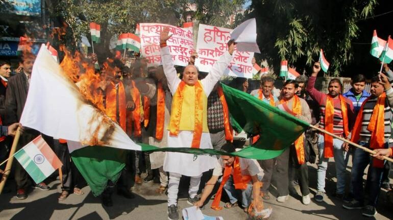 Activists of Shiv Sena and Dogra Front burn a Pakistani national flag in Jammu on Friday, during a protest against the Lahore High Court's order releasing JuD chief Hafiz Saeed. (PTI)