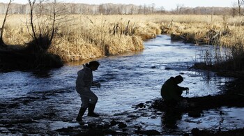 Greenpeace measuring water from Techa river outside the village of Muslyumovo November 19, 2010. The village is located on the banks of the Techa river in Russia's Urals, one of the country's most lethal nuclear dumping grounds. The Mayak nuclear complex located 30 km (18 miles) from Muslyumovo, currently processing foreign radioactive wastes, dumped 76 million cubic metres (2.68 billion cubic feet) of highly radioactive waste into the river from 1949 to 1956. Picture taken November 19, 2010. REUTERS/Denis Sinyakov (RUSSIA - Tags: HEALTH DISASTER ENVIRONMENT) - GM1E6BN0E8S01