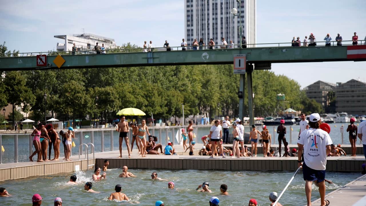A lifeguard watches over swimmers of the three swimming areas open up along the Bassin de la Villette, as part of the Paris Plages summer festival in Paris, France, July 18, 2017. REUTERS/Charles Platiau - RC1A46C619A0