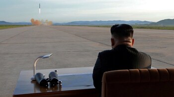 North Korean leader Kim Jong Un watches the launch of a Hwasong-12. (KCNA via Reuters)