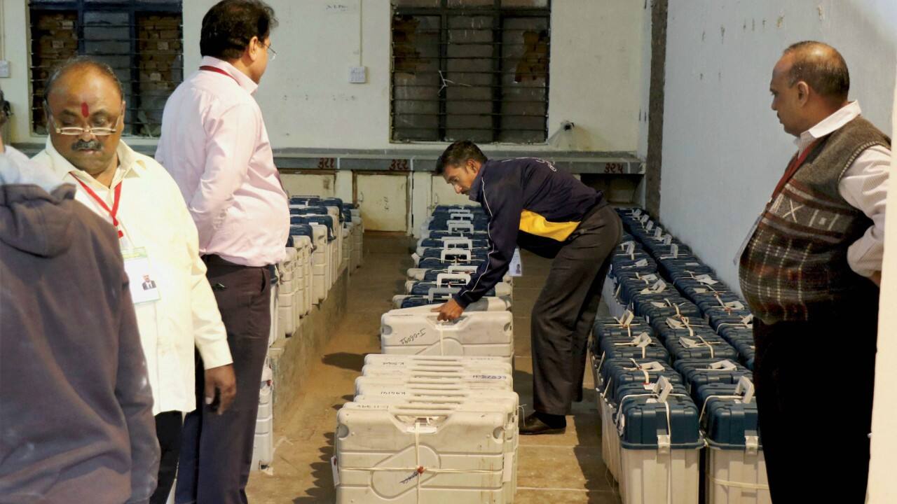 Election officers arrange the EVM machines inside the strong room on the day of state assembly election result, in Ahmedabad on Monday. (PTI)