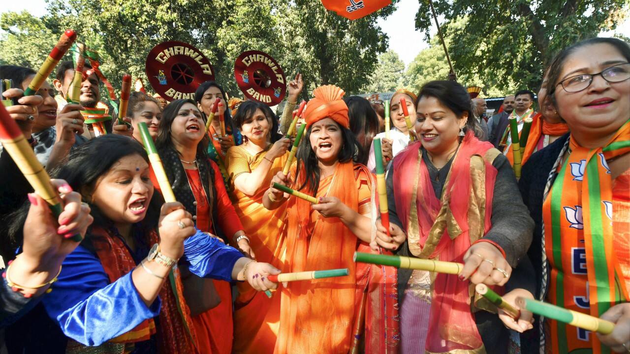Party workers and supporters celebrate their success in Gujarat and Himachal Pradesh state assembly elections, in New Delhi on Monday. (PTI) 