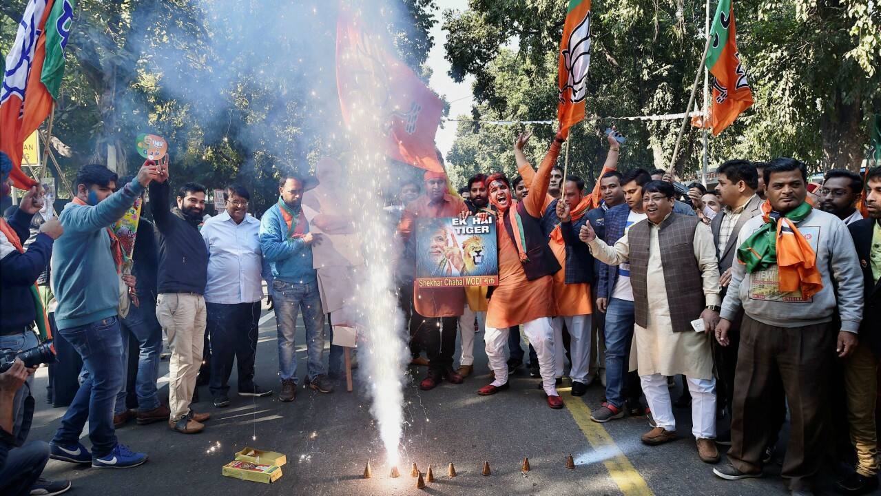 BJP supporters celebrating the party's success in the state assembly elections outside the BJP headquarter, in New Delhi on Monday. (PTI) 
