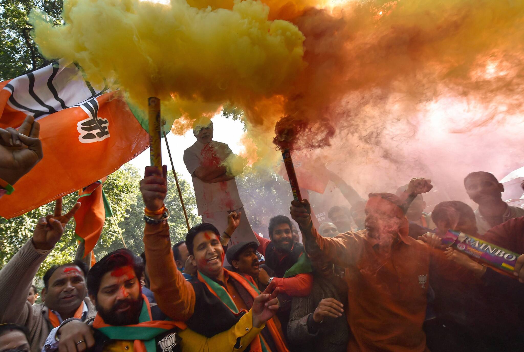 Party supporters celebrating BJP's success in the Gujarat and Himachal Pradesh state assembly elections, outside the BJP headquarters in New Delhi on Monday. (PTI) 