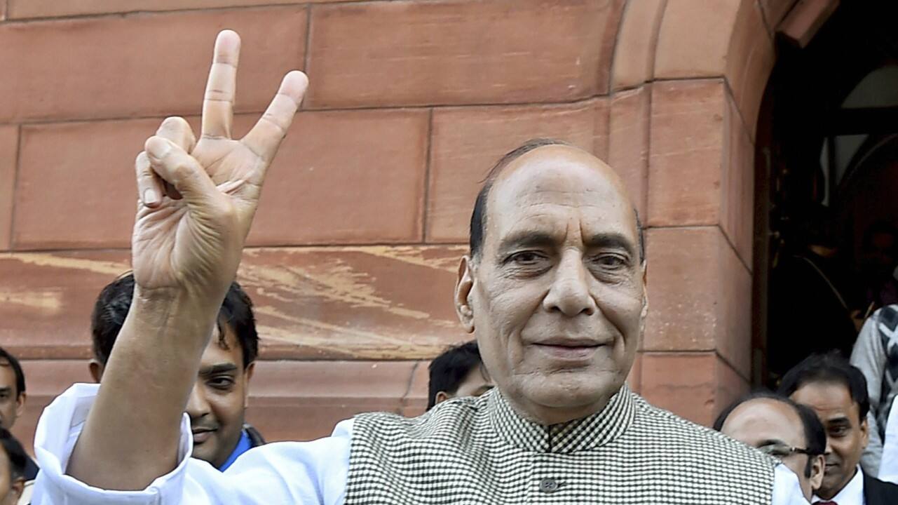 Home Minister Rajnath Singh flashes victory sign after BJP’s success in Himachal and Gujarat assembly elections, during the winter session of Parliament, in New Delhi on Monday. (PTI) 