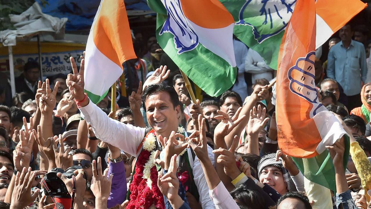  Congress party's Jamalpur-Khadia seat candidate Imran Khedawala flashes victory sign along with his supporters, as he celebrates his win in Assembly elections, outside the Gujarat College counting centre in Amedabad on Monday. (PTI) 