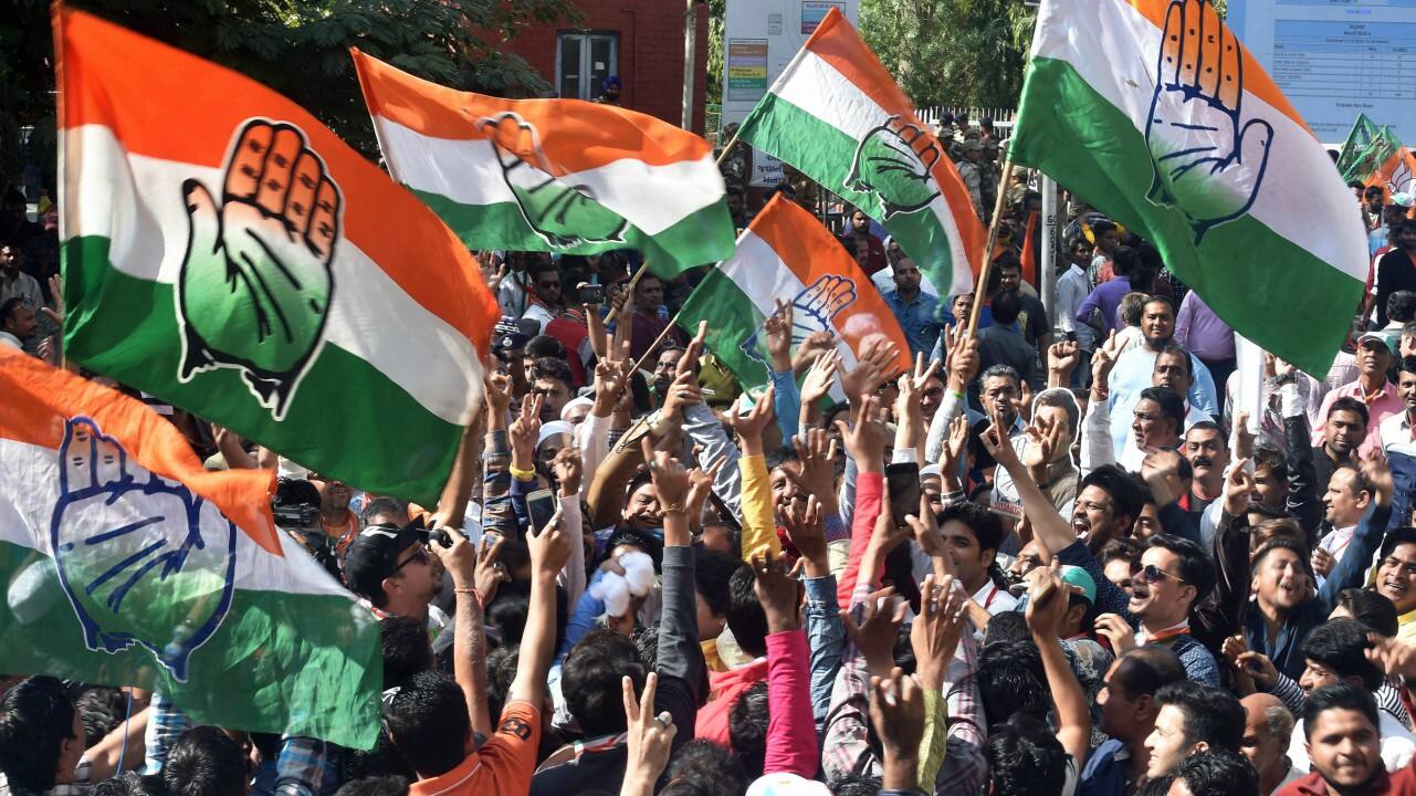 Congress party supporters celebrate after a party candidate's win in the Assembly elections, outside the Gujarat College counting centre in Amedabad on Monday. (PTI) 