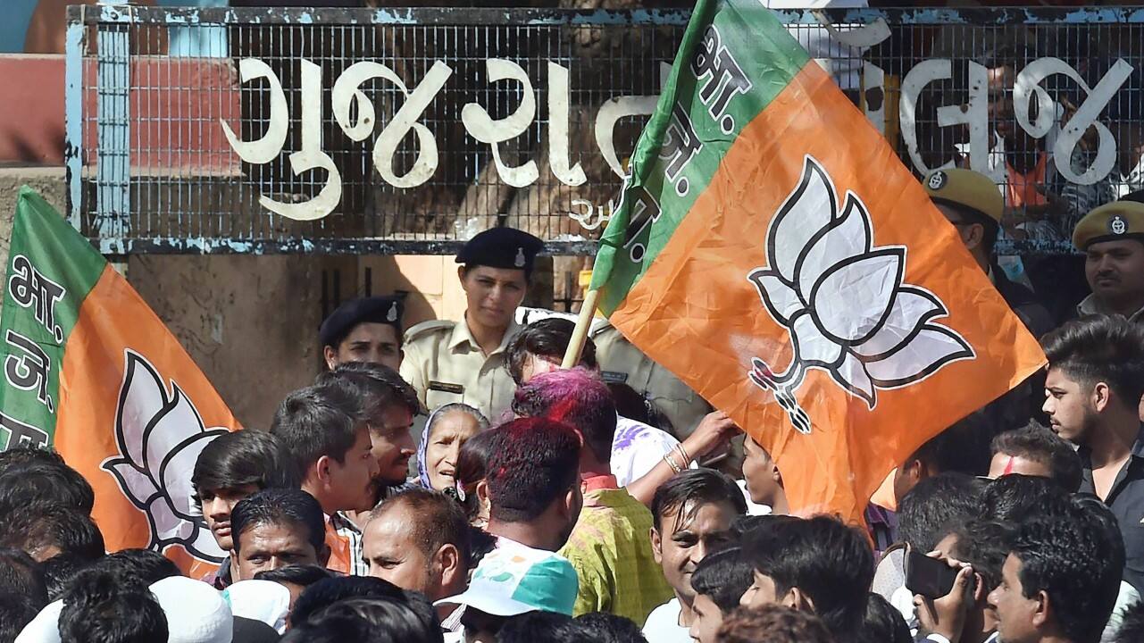 BJP supporters celebrate their win in the Assembly elections, outside the Gujarat College counting centre in Ahmedabad on Monday. (PTI) 