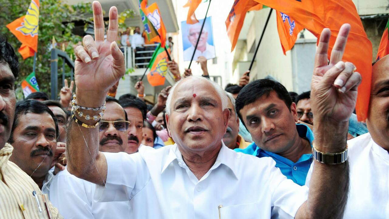 Karnataka BJP BS Yeddyurappa flashes victory sign along with the party members to celebrate the party's victory in Gujarat and Himachal Pradesh Assembly elections, in Bengaluru on Monday. (PTI) 