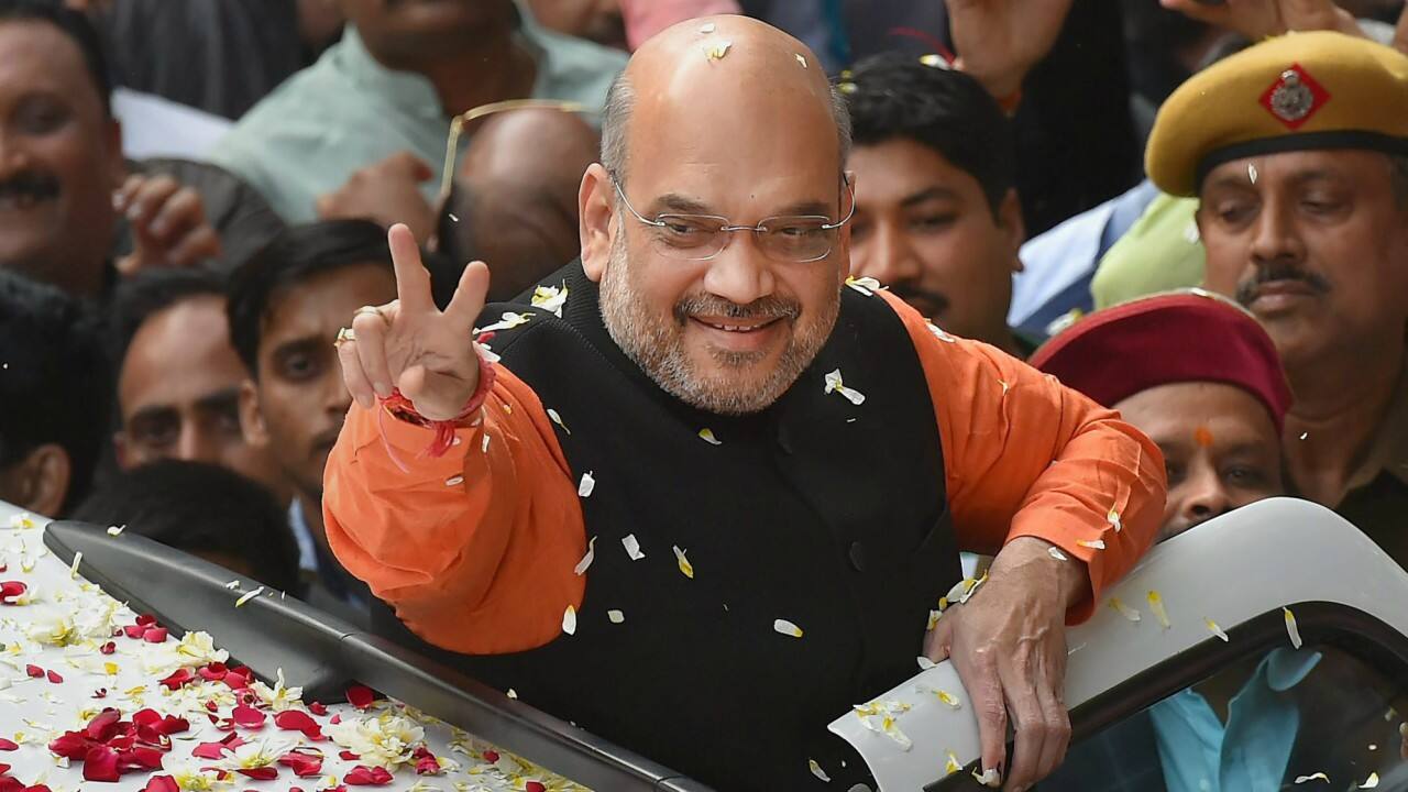  BJP President Amit Shah gestures while being welcomed on his arrival at the party headquarters in New Delhi on Monday, after the party's victory in the Assembly elections in Gujarat and Himachal Pradesh. (PTI) 