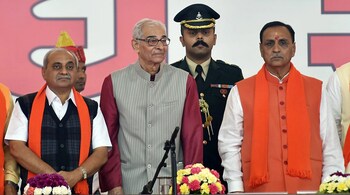 Gandhinagar: Gujarat Chief Minister Vijay Rupani and Deputy CM Nitin Patel along with Governor Om Prakash Kohli during the swearing-in ceremony at Gandhinagar, Ahmedabad on Tuesday. PTI Photo by Santosh Hirlekar (PTI12_26_2017_000036B)