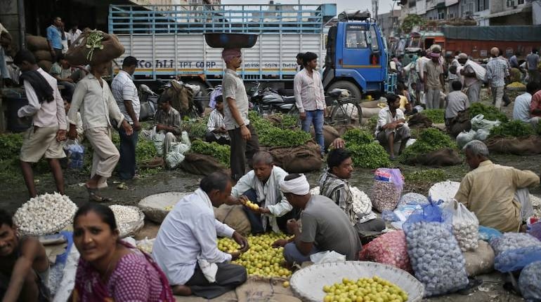 Street Vendors and customers at a wholesale vegetable and fruit market in New Delhi (REUTERS)