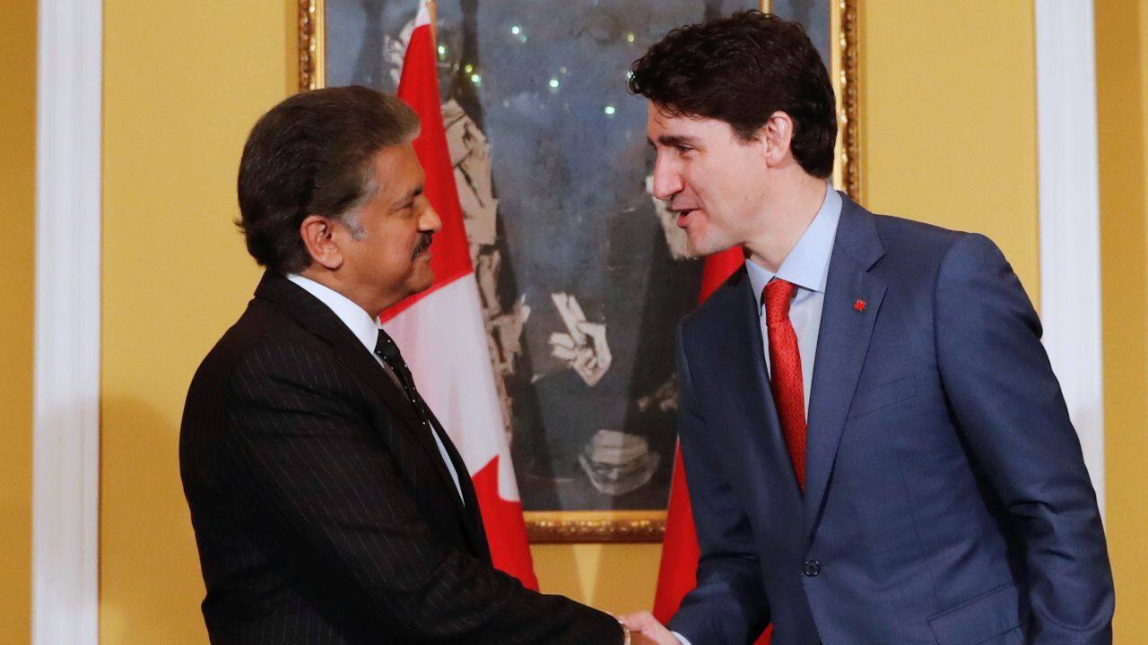 Canadian PM shakes hand with Anand Mahindra, Chairman of Mahindra Group during a meeting in Mumbai on Tuesday. (Reuters)