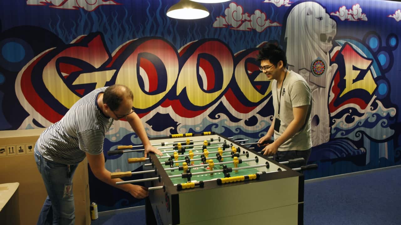 Google employees play table soccer at a recreational area of their Singapore office. (Reuters) Google employees play table soccer at a recreational area of their Singapore office. (Reuters)