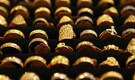 Gold price eases on firm dollar ahead of central bank meetings