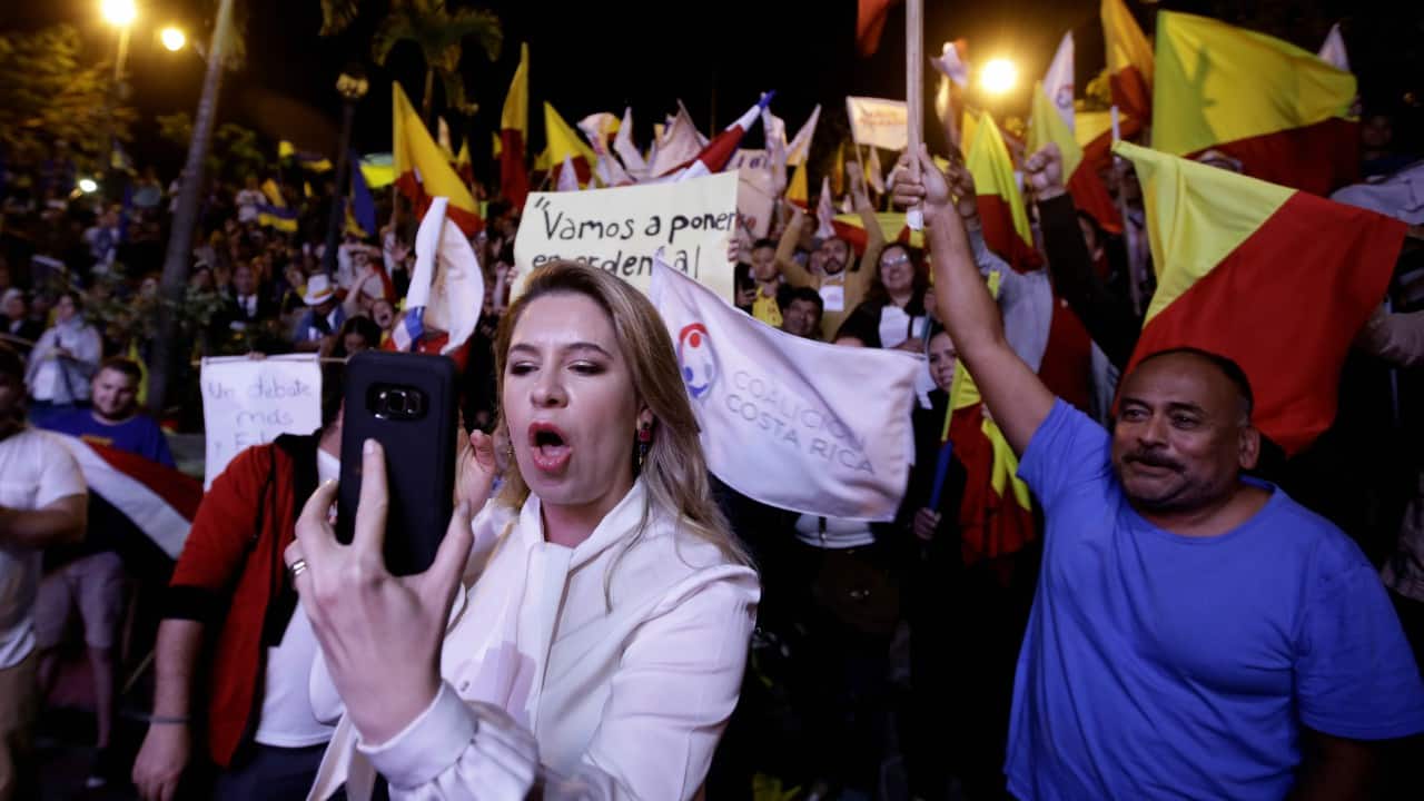 Claudia Dobles wife of Presidential candidate of the ruling Citizens' Action Party (PAC), Carlos Alvarado, make a video from your cell phone during a live televised debate before a second-round presidential election runoff at Supreme Election Tribunal in San Jose, Costa Rica. (REUTERS) Claudia Dobles wife of Presidential candidate of the ruling Citizens' Action Party (PAC), Carlos Alvarado, make a video from your cell phone during a live televised debate before a second-round presidential election runoff at Supreme Election Tribunal in San Jose, Costa Rica. (REUTERS)