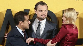 Producer Riza Aziz (L), and cast members Leonardo DiCaprio and Margot Robbie arrive for the U.K. Premiere of "The Wolf of Wall Street" at Leicester Square, London January 9, 2014.