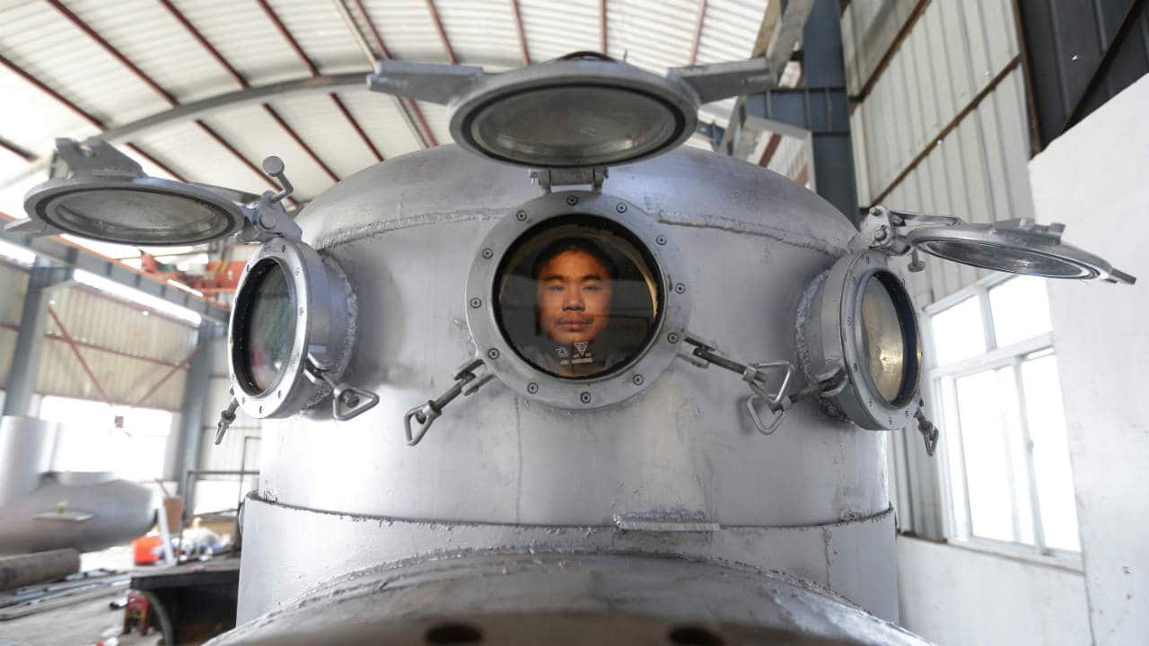 Zhang Wuyi sits in his newly made multi-seater submarine at his new workshop near an artificial pool in Wuhan. Zhang, a 37-year-old local farmer, who is interested in scientific inventions, has independently made seven miniature submarines with several fellow engineers, one of which was sold to a businessman in Dalian at a price of 100,000 yuan (USD 15,855) last October. The submarines, mainly designed for harvesting aquatic products, such as sea cucumber, have a diving depth of 20-30 metres (66-98 feet), and can travel for 10 hours, local media reported. (REUTERS)