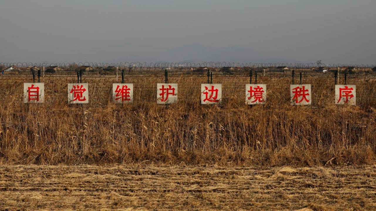 This sign stands in a field at the border between China and North Korea just outside Dandong, Liaoning province in China reads: &quot;Take the initiative to preserve order along the border.&quot; (Image: Reuters)