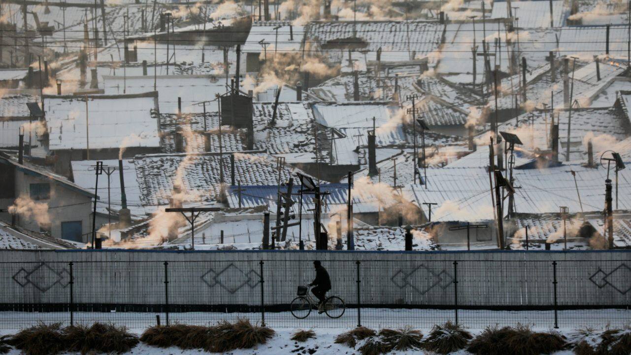 A North Korean man is photographed from north of Dandong, China along the border town of Changbai, as he rides a bicycle along the Yalu River in the North Korea's Hyesan. (Image: Reuters)