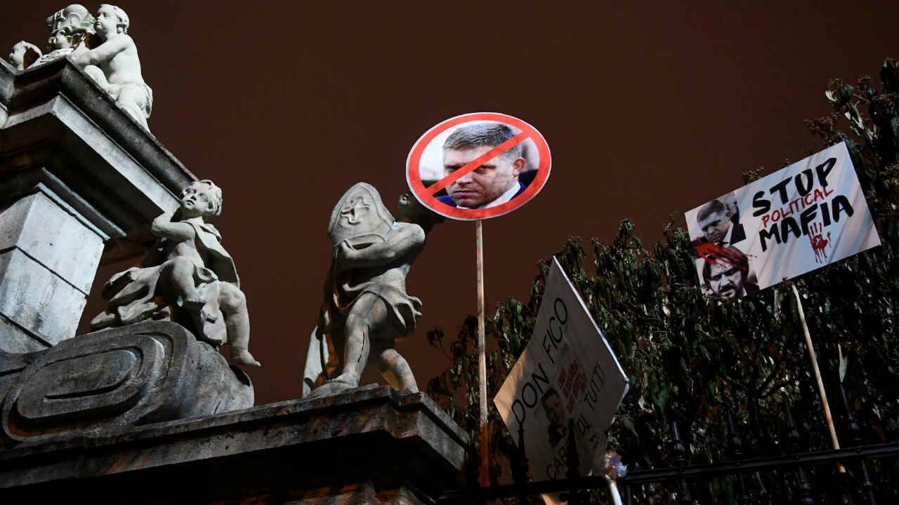 Slovakia | Prime Minister Robert Fico called journalists “filthy anti-Slovak prostitutes” and “idiotic hyenas,” that pushed the country 10 spots to 25. Banners with portraits of Slovakia's Prime Minister Robert Fico are seen on the fence of the building of the Government of the Slovak Republic during a march in honour of murdered Slovak investigative reporter Jan Kuciak and his girlfriend Martina Kusnirova. (Image: Reuters)
