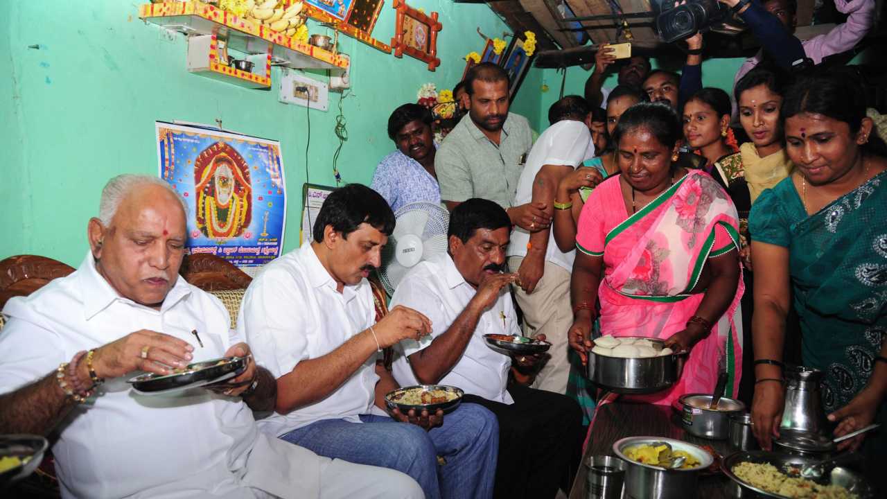 BJP State President & Chief Minister Candidate BS Yeddyurappa with other leaders having breakfast at a Dalit's house during his campaign for Karnataka Assembly Elections in Nelmangla near Bengaluru on 14th April 2018. (PTI Photo) BJP State President & Chief Minister Candidate BS Yeddyurappa with other leaders having breakfast at a Dalit's house during his campaign for Karnataka Assembly Elections in Nelmangla near Bengaluru on 14th April 2018. (PTI Photo)