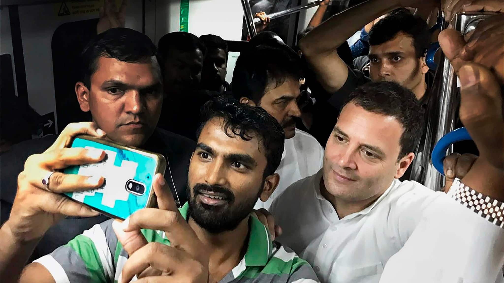 Congress chief Rahul Gandhi poses for a selfie with a commuter in a metro train ahead of Karnataka Assembly elections in Bengaluru on 8th April 2018. (PTI Photo) Congress chief Rahul Gandhi poses for a selfie with a commuter in a metro train ahead of Karnataka Assembly elections in Bengaluru on 8th April 2018. (PTI Photo)