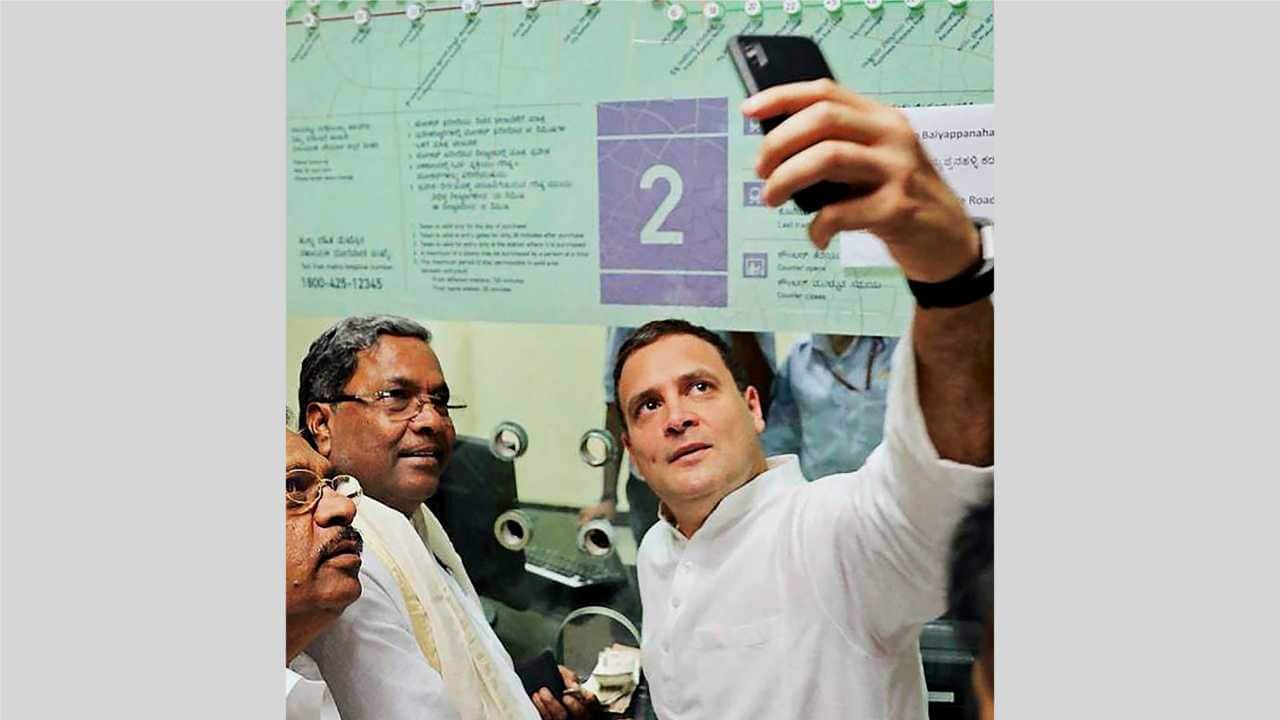 Rahul Gandhi takes a selfie with Karnataka Chief Minister Siddaramaiah and KPCC president G Parameshwara at a metro rail ticket counter ahead of Karnataka Assembly elections in Bengaluru on 8th April 2018. (PTI Photo) Rahul Gandhi takes a selfie with Karnataka Chief Minister Siddaramaiah and KPCC president G Parameshwara at a metro rail ticket counter ahead of Karnataka Assembly elections in Bengaluru on 8th April 2018. (PTI Photo)