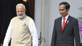 Indian Prime Minister Narendra Modi walks with Indonesian President Joko Widodo during their meeting at Merdeka Palace in Jakarta. (Photo: AP/PTI)